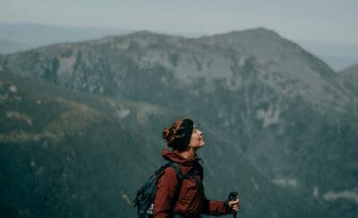 A hiker looks beyond herself on her trek.